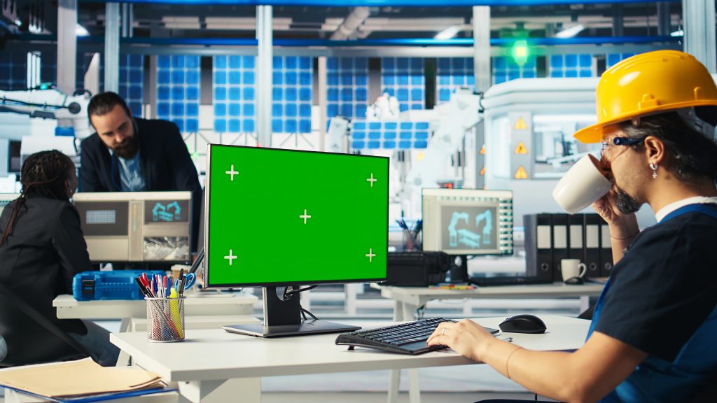 Engineer in solar panels plant uses CAD software on mockup PC to optimize layout