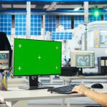 Engineer in solar panels plant uses CAD software on mockup PC to optimize layout